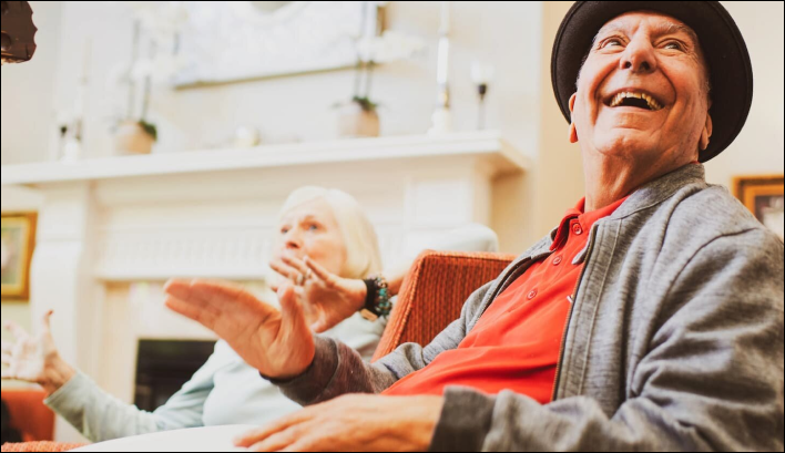 Senior man and woman smiling and socializing.
