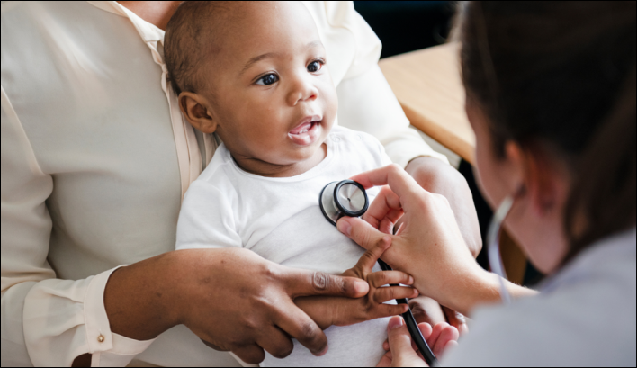 Image of a baby having their heart listened to by a doctor with a stethoscope