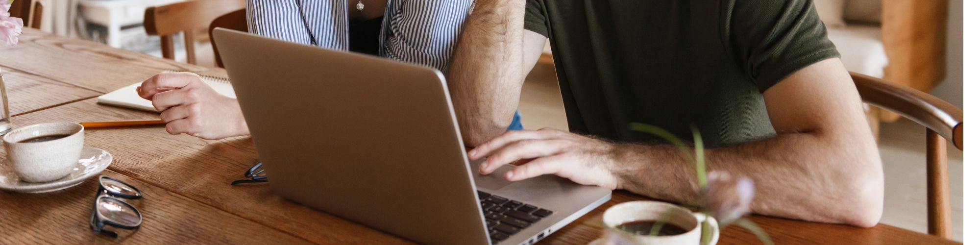 two people looking at a laptop