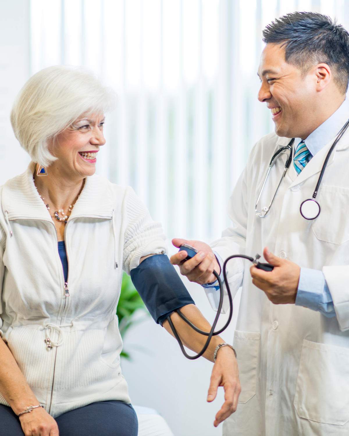 woman getting her blood pressure checked by a doctor